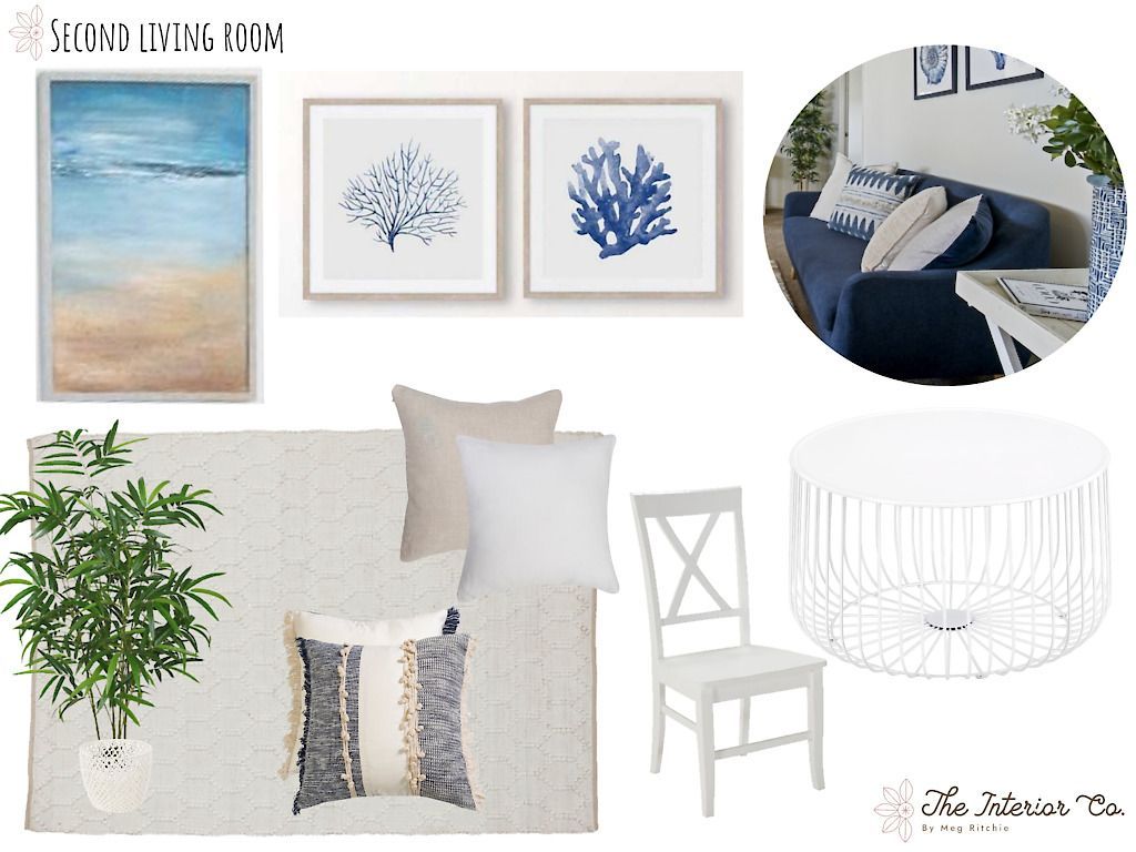 A living room with a blue couch and white furniture
