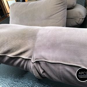 Cushion before and after cleaning; dirty, gray fabric with a visible clean area.