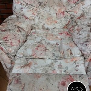 Floral-patterned recliner chair with pink and beige flowers.