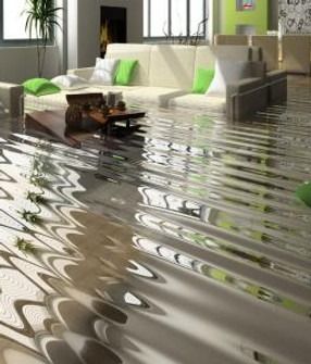 Living room flooded with water, furniture and objects submerged, white sofa with green pillows.