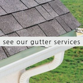 A gray shingled roof with a white gutter system, featuring the text