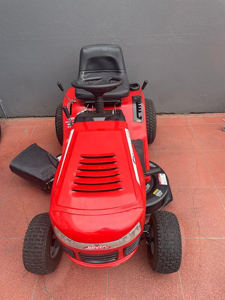 Red Riding Lawnmower on a Patio, Viewed From Above — Cairns Small Engine Repairs in Bentley Park, QLD