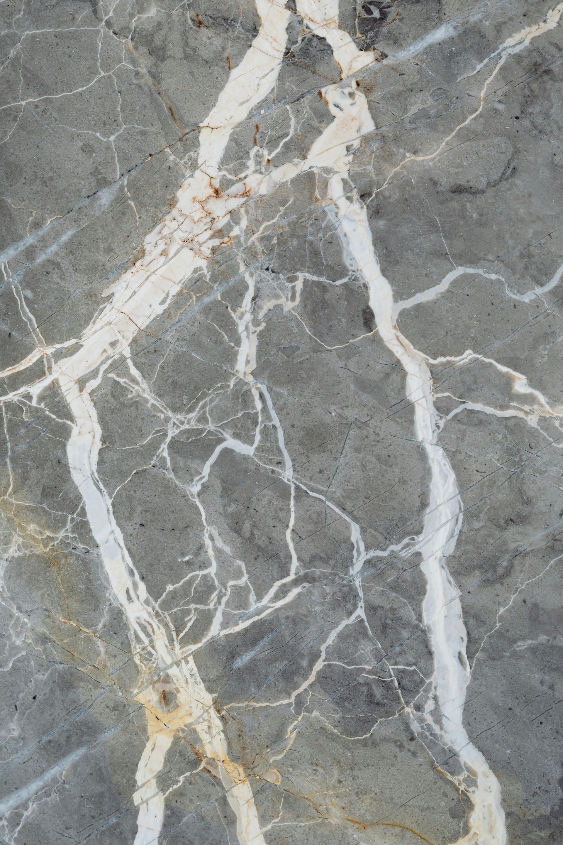 A close up of a gray marble texture with white veins