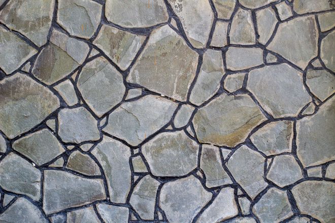 A close up of a stone wall with a geometric pattern