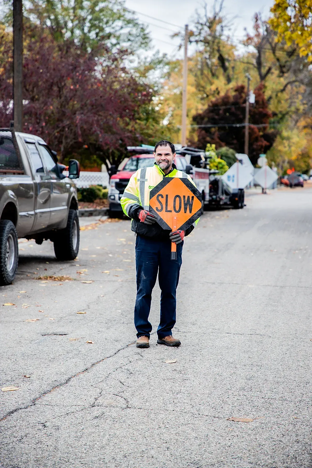 Plumber, Steve Jordan standing in street with slow down sign for Payette drivers
