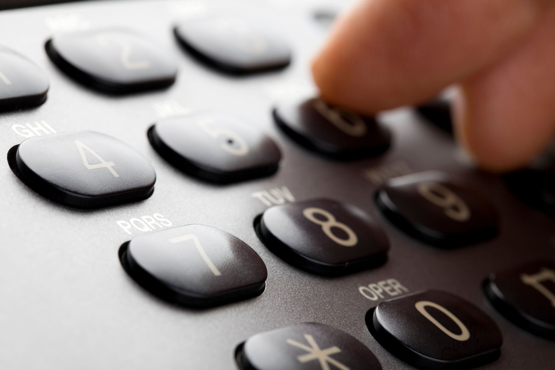 Finger pressing the number 