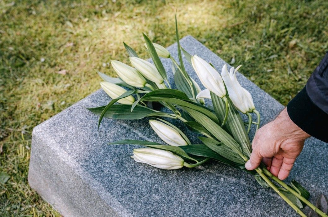White lilies placed on a graveside marker for funeral and cremation care in Bainbridge Island, WA