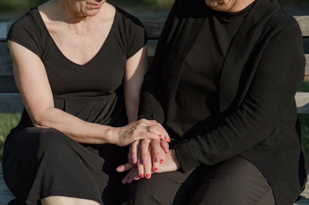 Two people holding hands in support, reflecting thoughtful funeral and cremation care for Poulsbo families