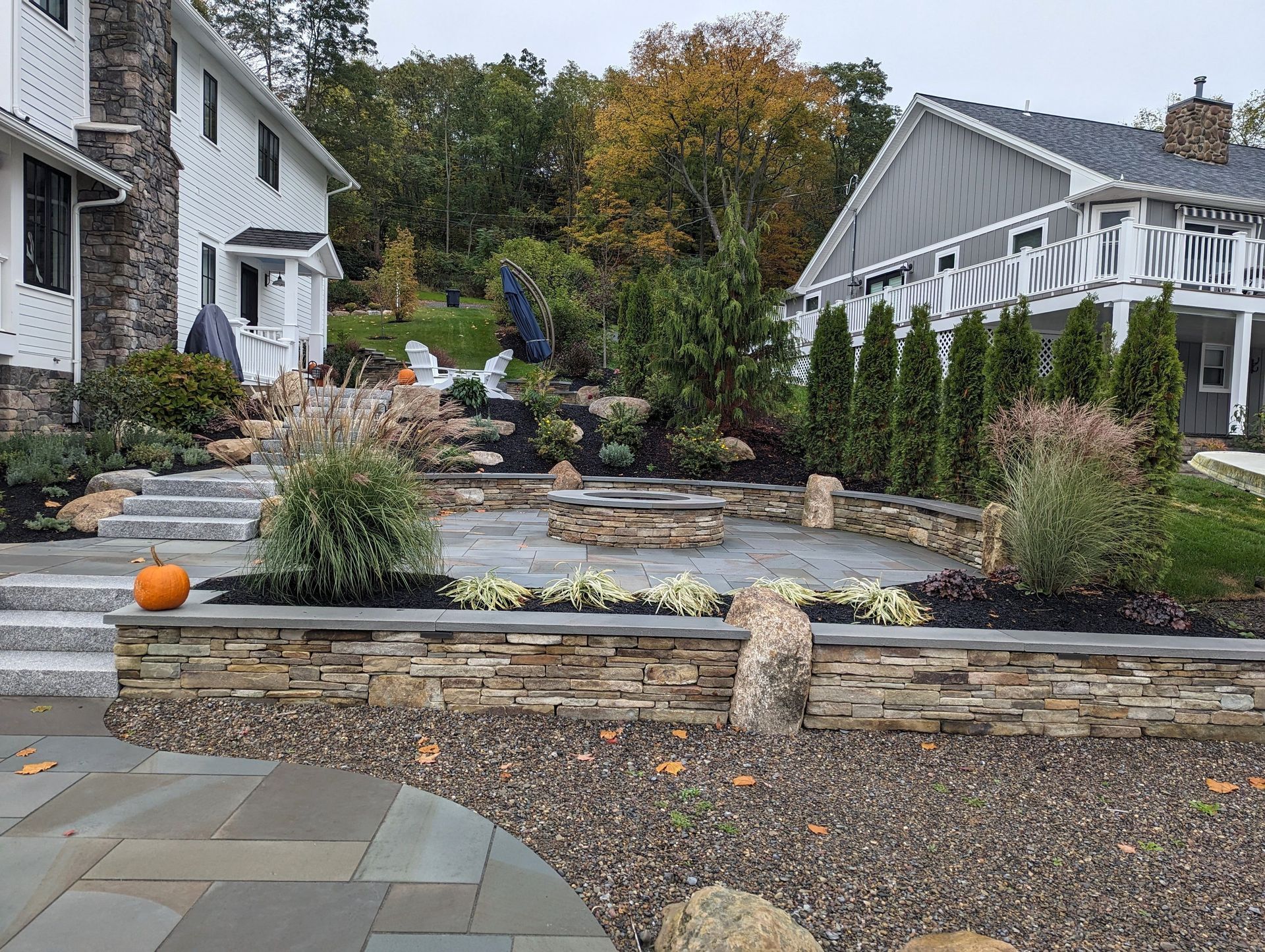 There is a pumpkin in the garden in front of the house.