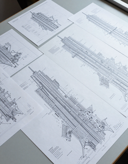 NYC zoning maps and architectural drawings on drafting table