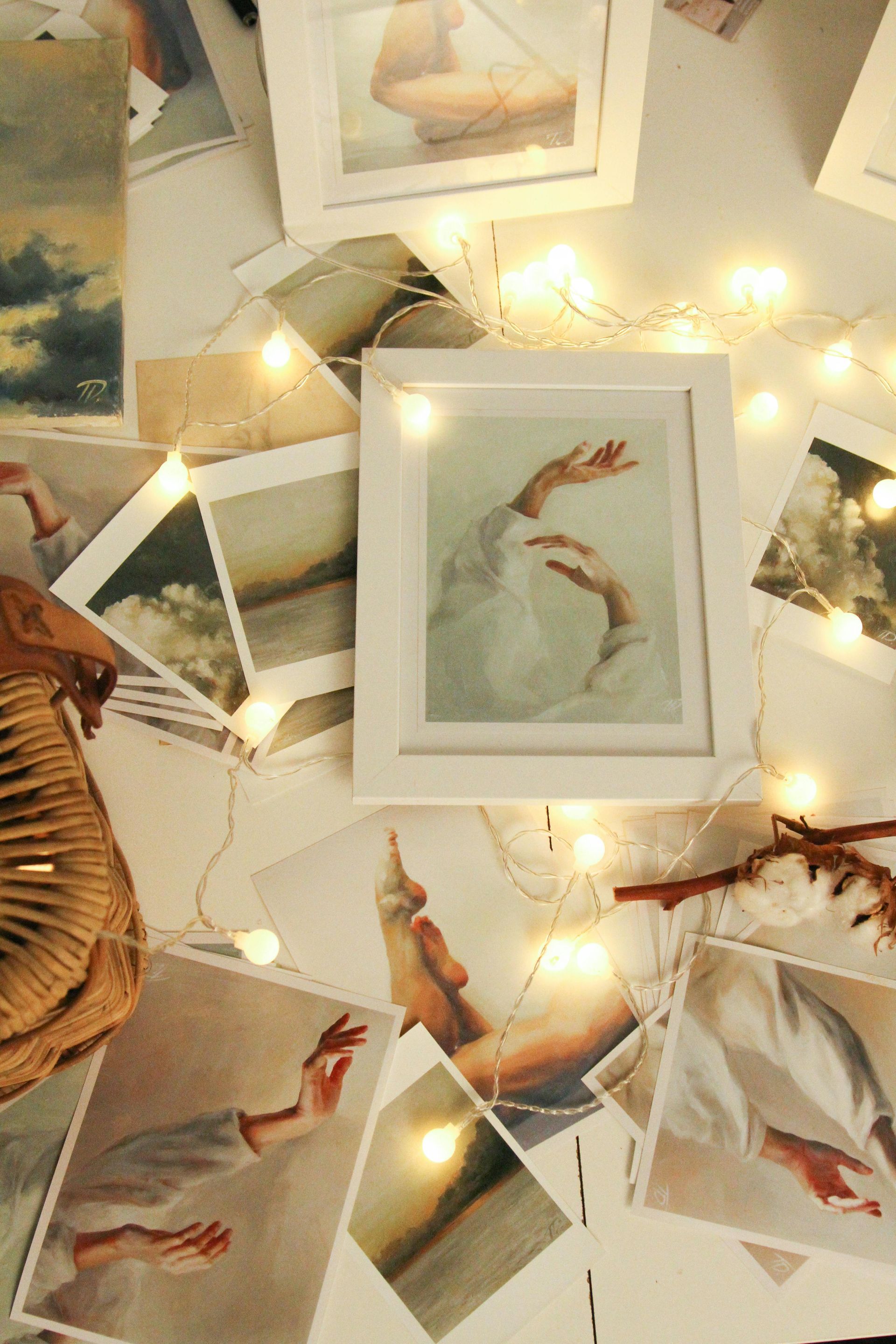A living room with a couch and a collage of pictures on the wall.