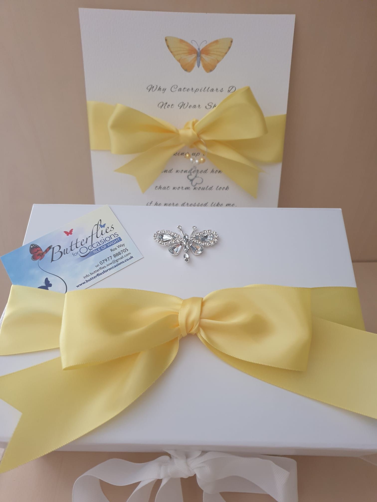 White box and card set, yellow ribbon with a rhinestone embellishment and bow, butterfly theme.