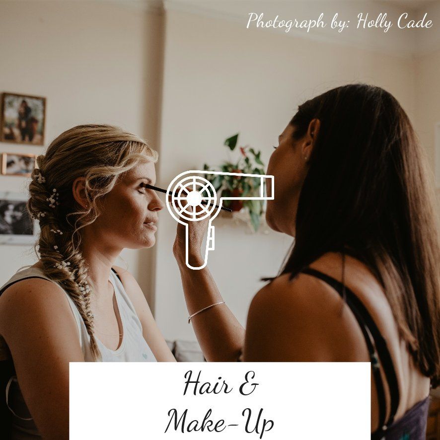 Woman having makeup applied by another woman, interior shot, hair styling.