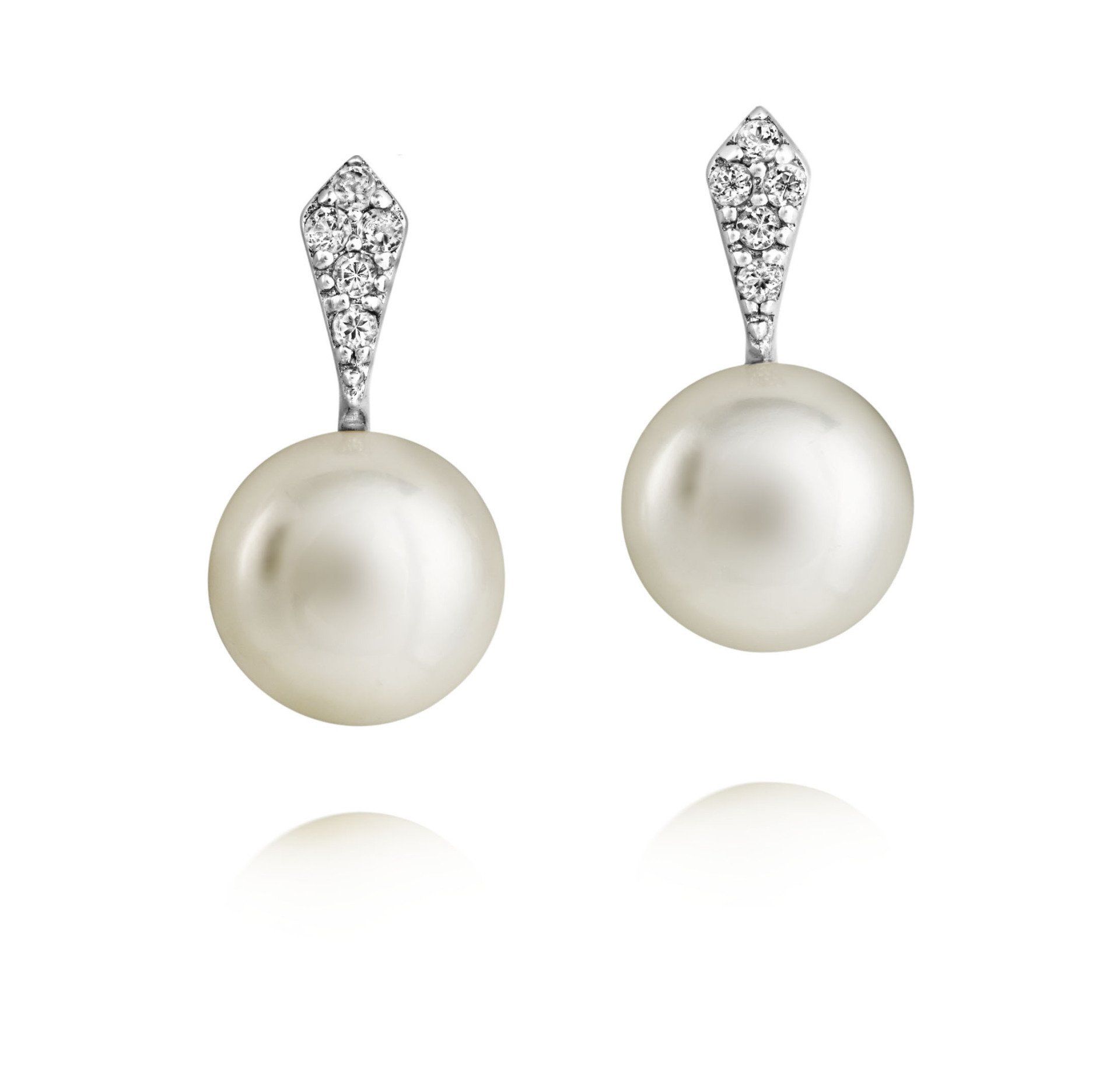 Pair of pearl drop earrings with diamond-encrusted tops, reflecting light.