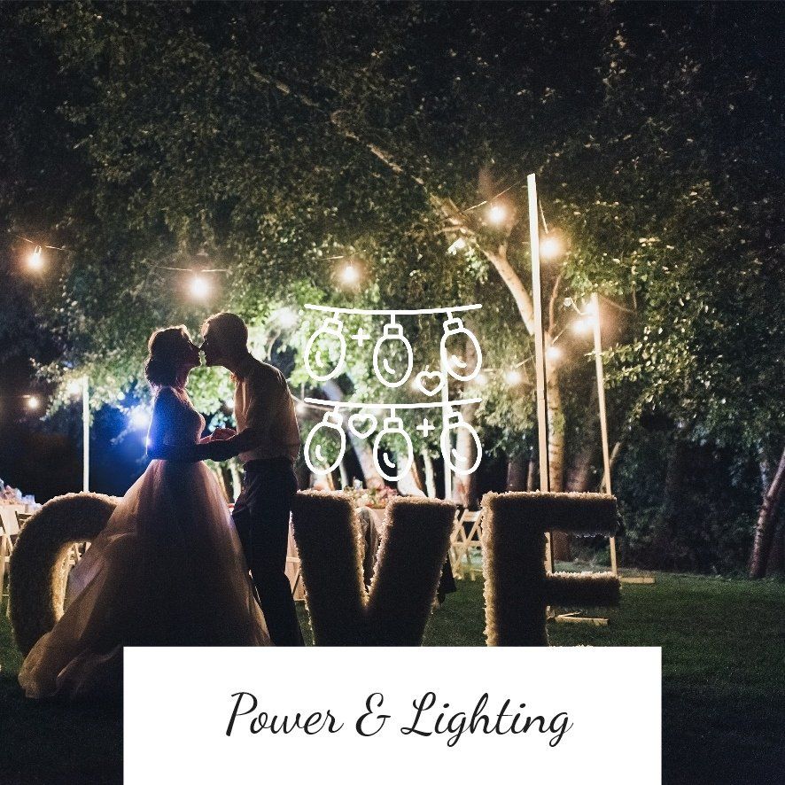 Couple kissing under lights at wedding with illuminated