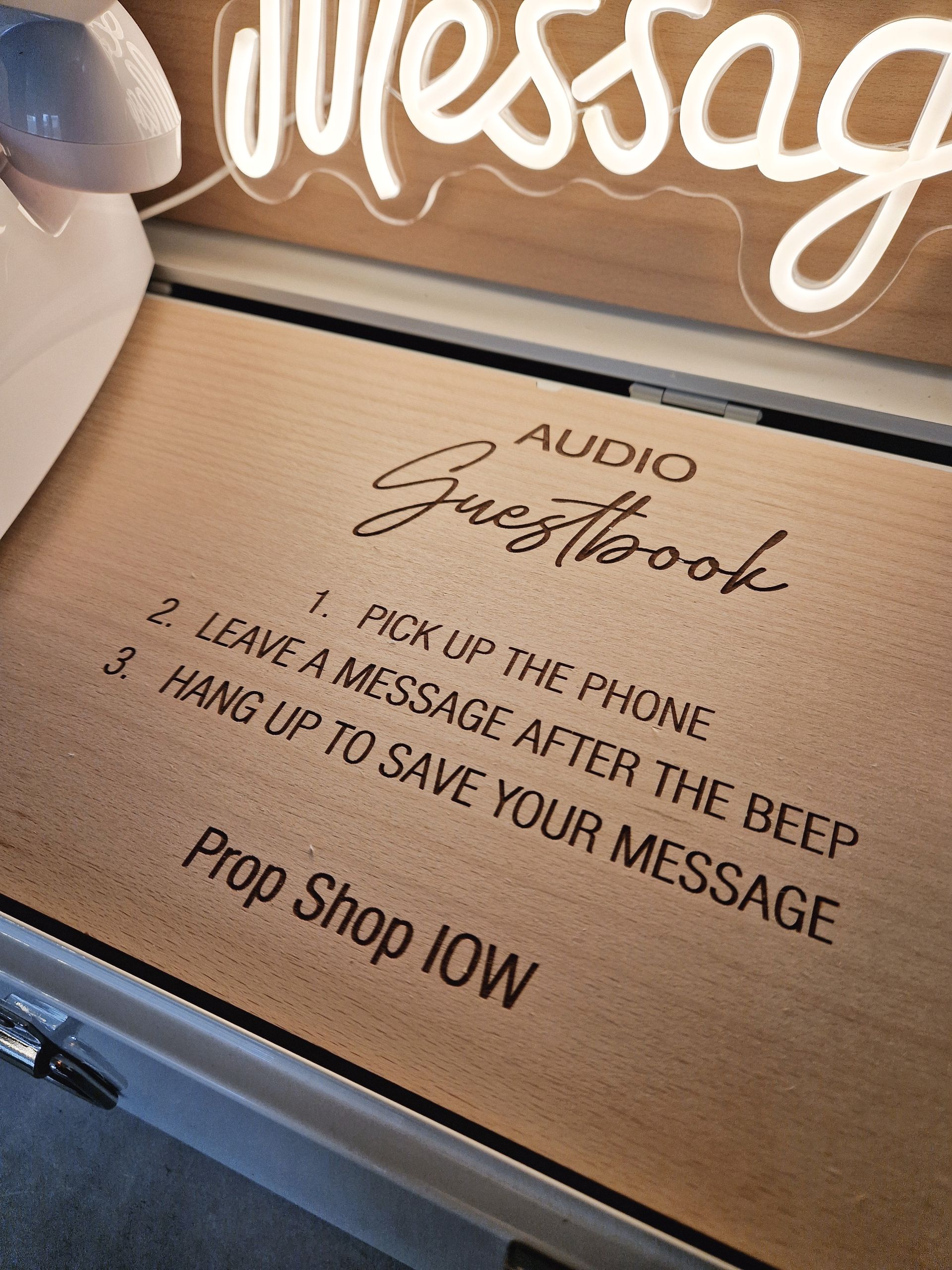 Wooden audio guestbook with instructions: pick up the phone, leave message after beep, hang up to save.