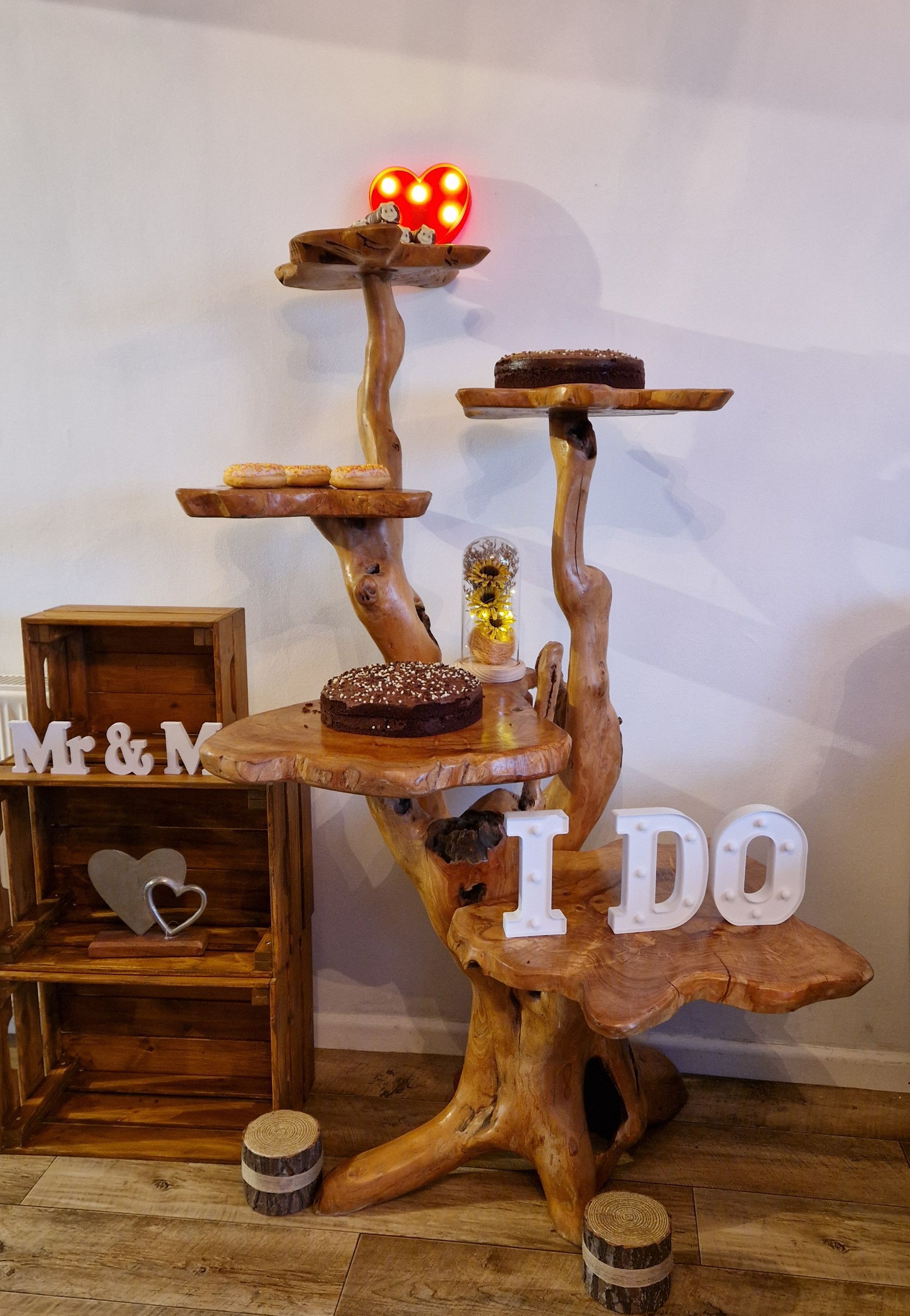 Wooden tiered dessert stand with cakes,
