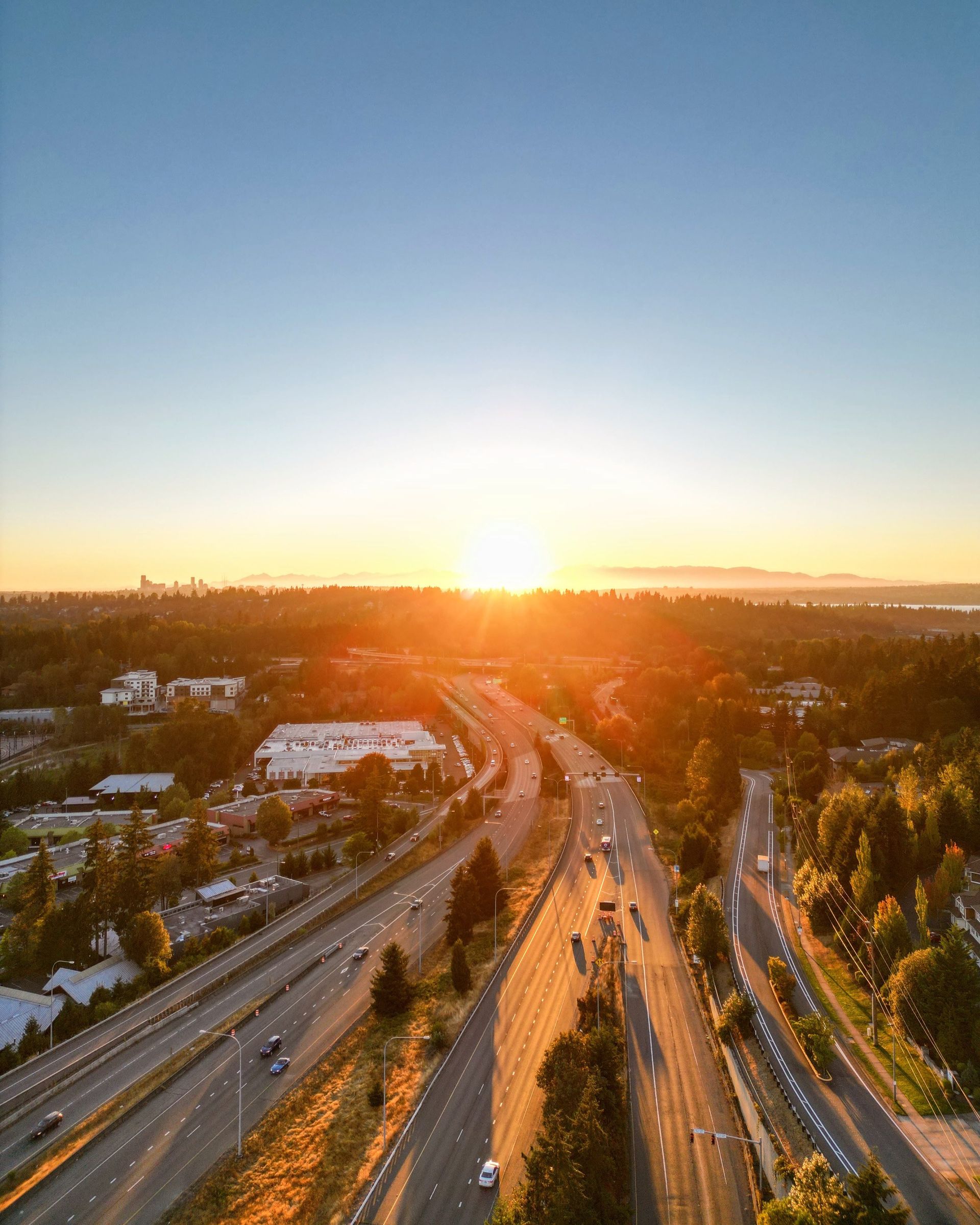 An aerial view of a highway at sunset.