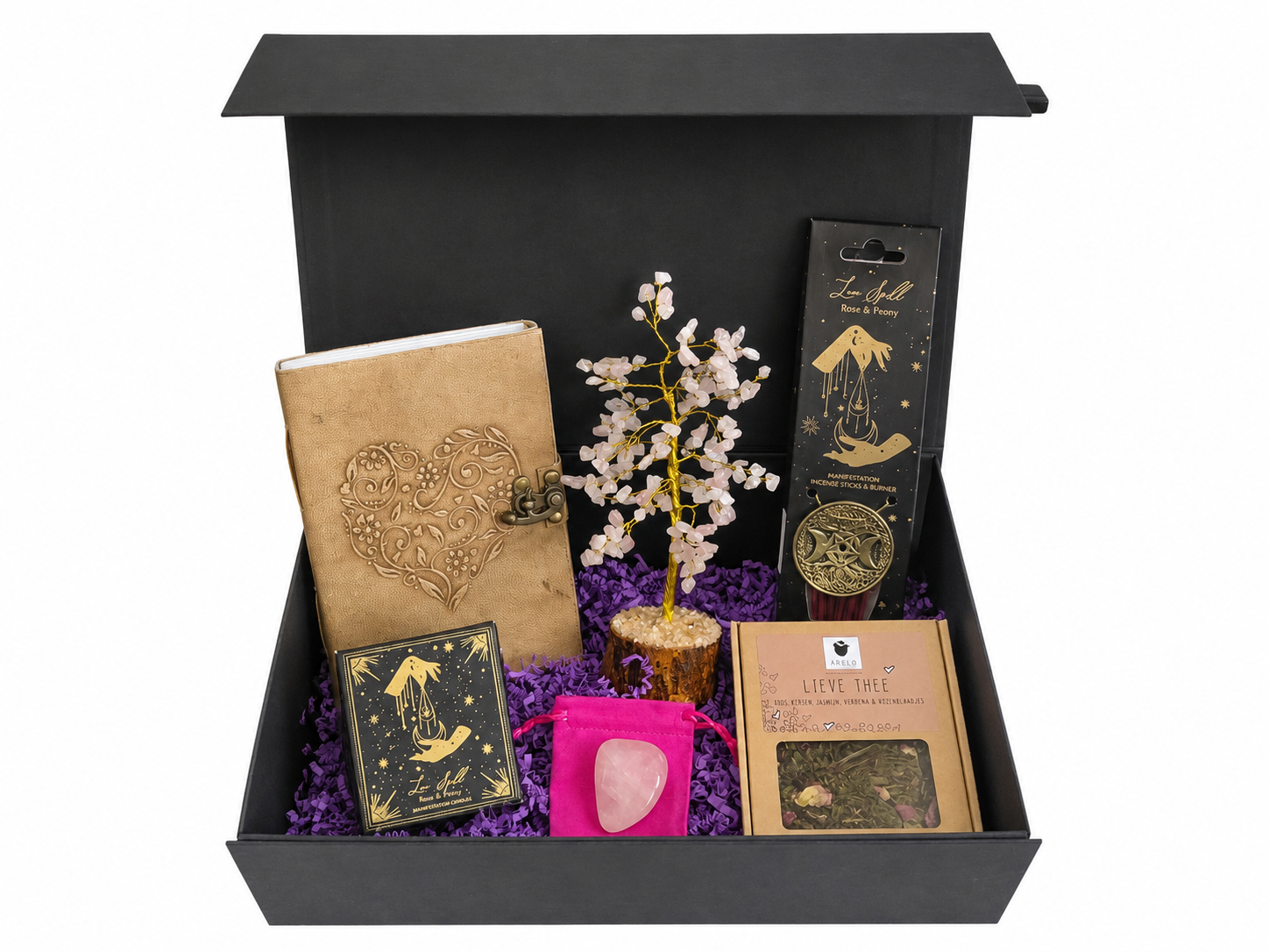 Zwarte geschenkdoos gevuld met diverse schrijfwaren, bloemen en decoratieve artikelen.