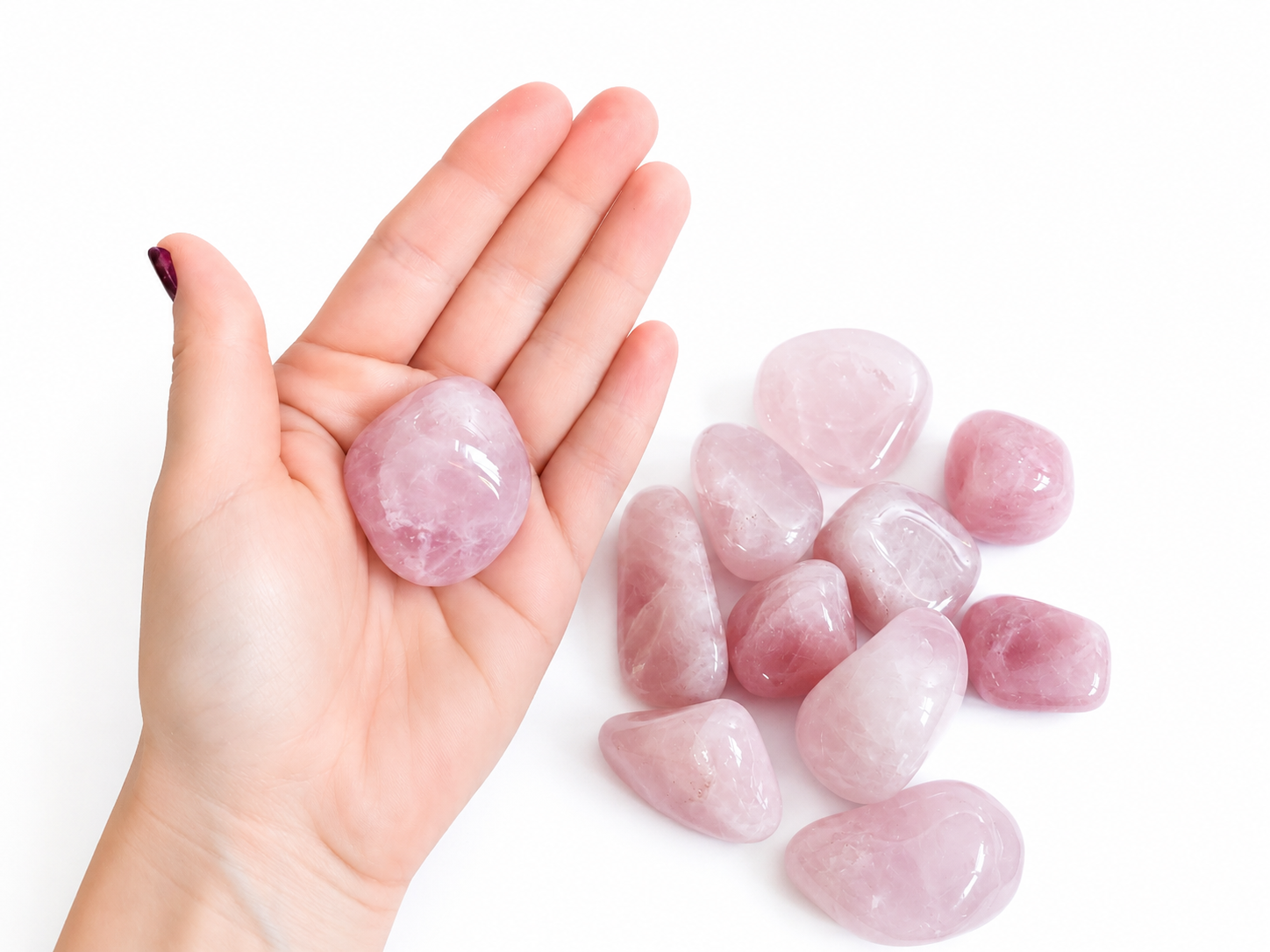 Roze gepolijste rozenkwartsstenen op een witte achtergrond