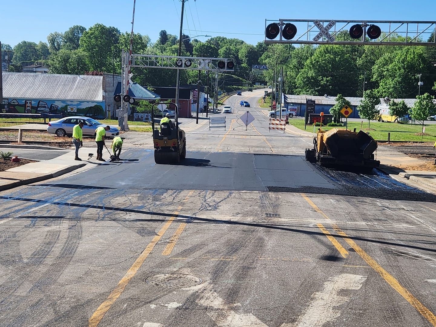 A group of construction workers are working on a road