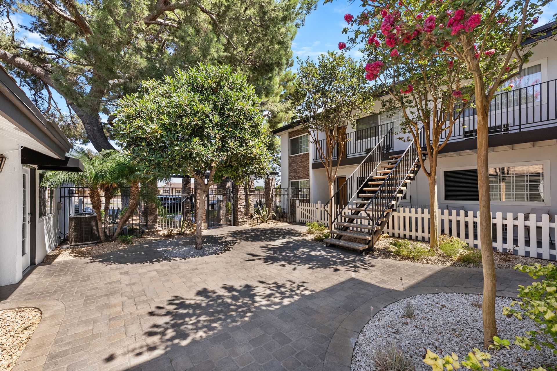shaded courtyard with stairs to apartment building