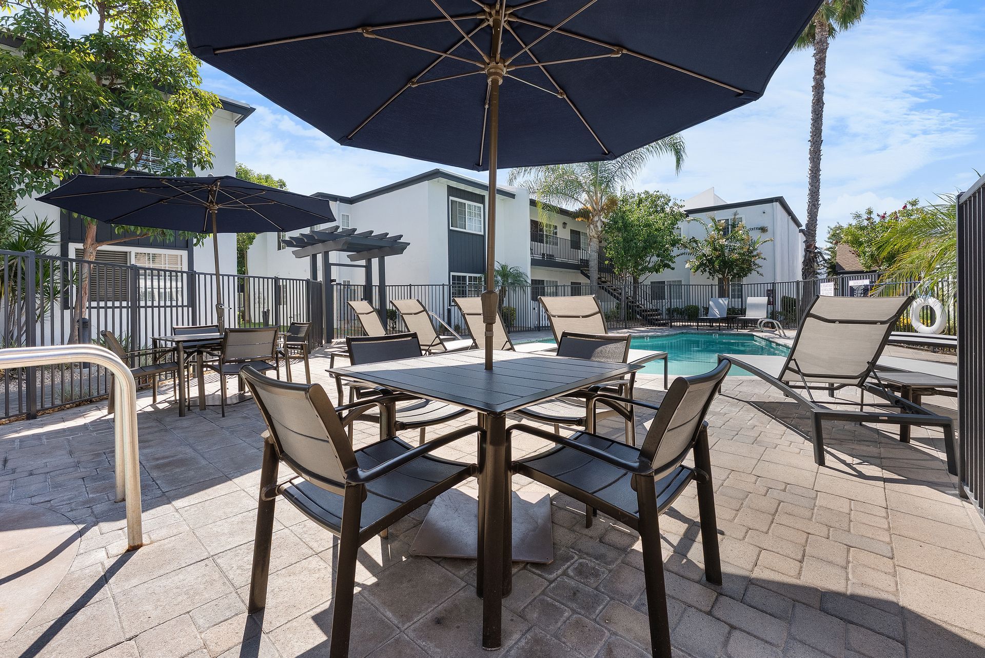 poolside table with chairs and umbrella