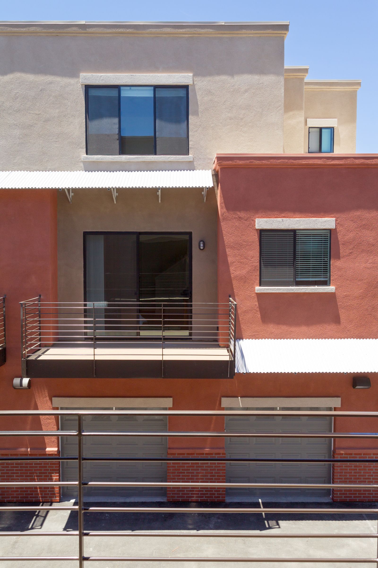 A building with a balcony and sliding glass doors