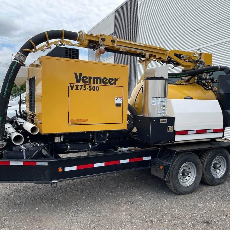 Pelle aspirante jaune Vermeer VX75-500 sur une remorque stationnée à l'extérieur