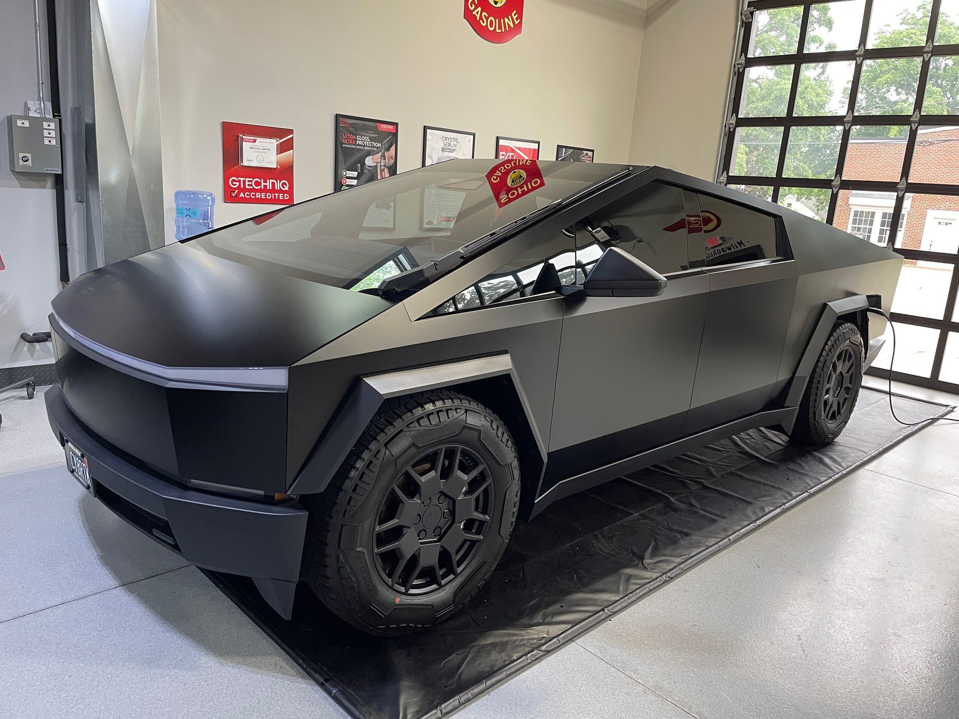 Matte black Tesla Cybertruck parked inside a building.