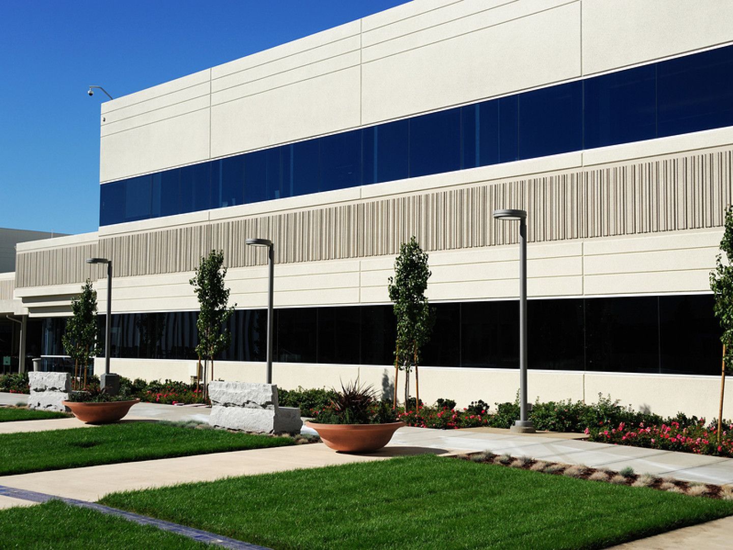 A large white building with a blue stripe on the side