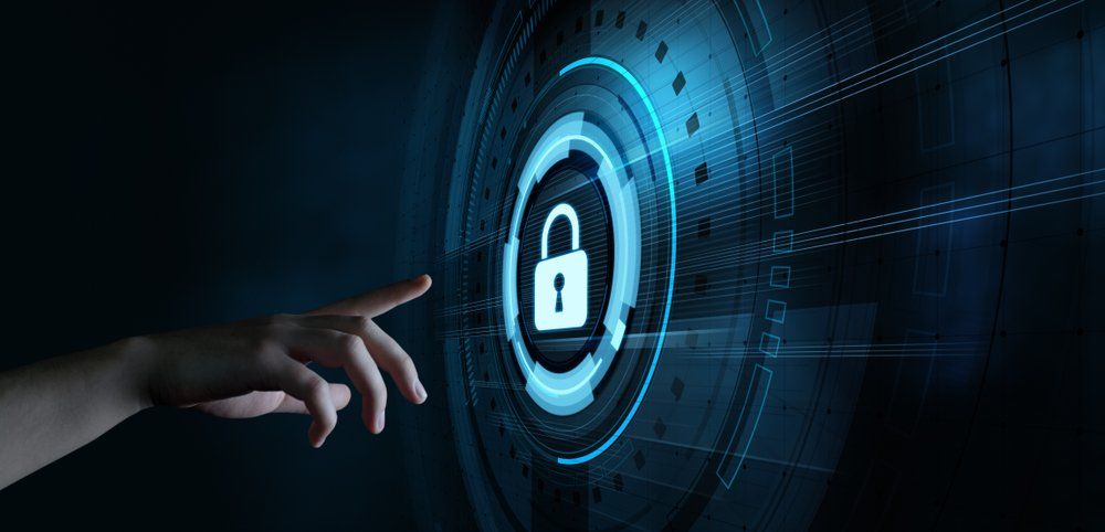 Hand touching a digital screen with a glowing lock icon, symbolizing security and protection.