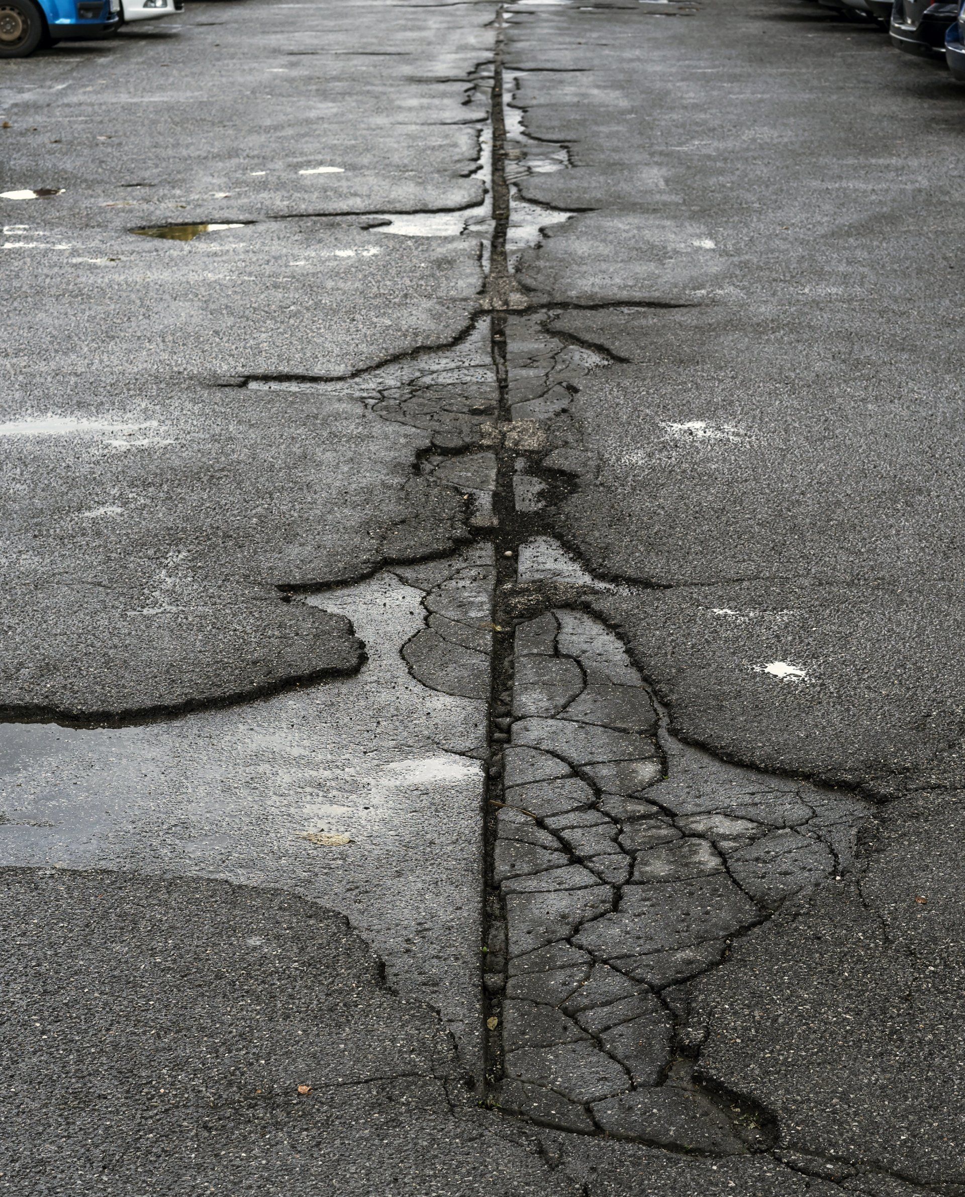 Very damaged and cracked parking space - Wendell, NC - Champ's Paving & Seal Coating INC