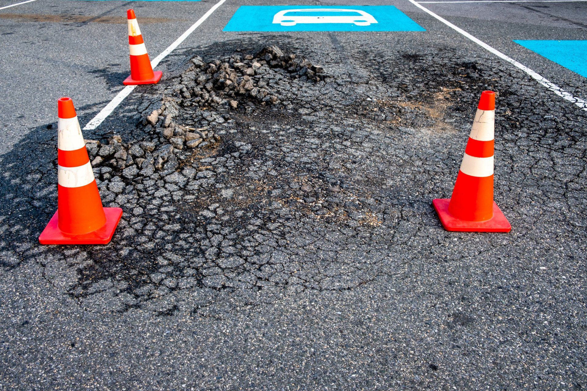 Damaged surface of asphalt road - Wendell, NC - Champ's Paving & Seal Coating INC