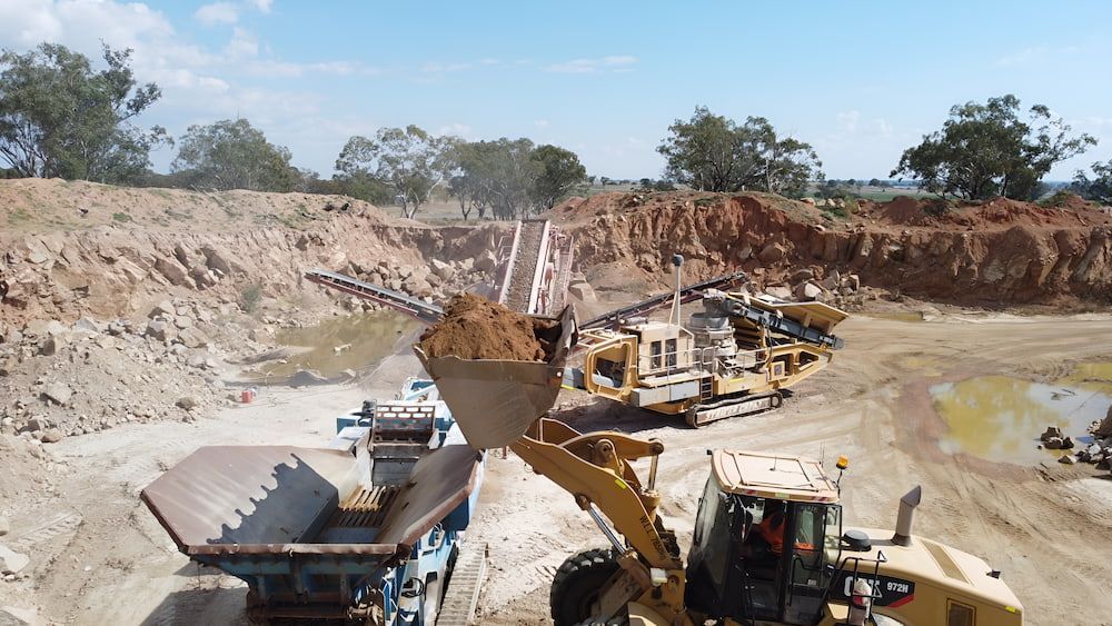 A Bulldozer Is Loading Dirt Into A Dump Truck — Macquarie Valley Rock & Sand In Narromine, NSW 