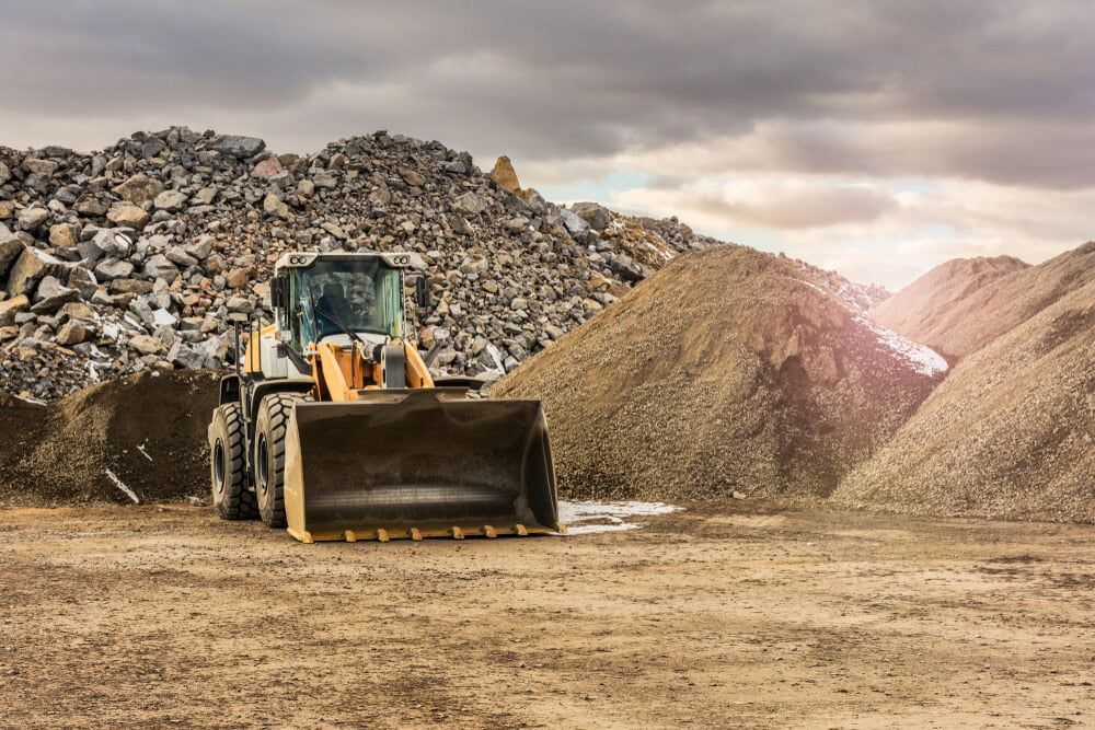 A Bulldozer Is Sitting In Front Of A Pile Of Rocks — Macquarie Valley Rock & Sand In Warren, NSW