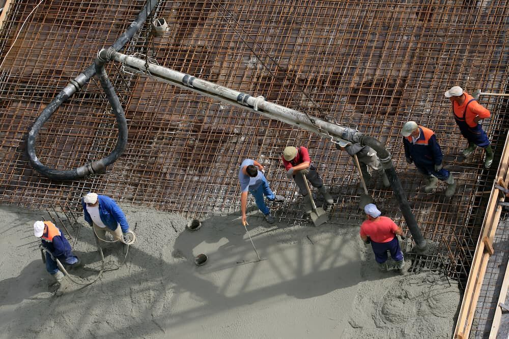 A Group Of Construction Workers Are Working On A Concrete Floor — Macquarie Valley Rock & Sand In Narromine, NSW