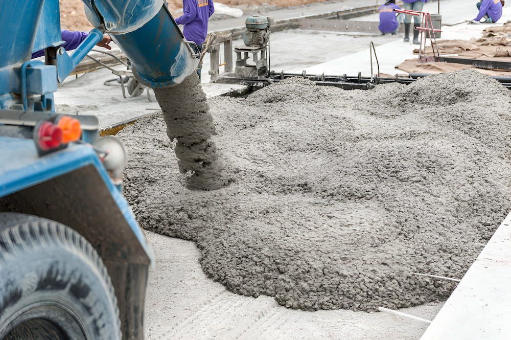 A Truck Is Pouring Concrete On A Construction Site — Macquarie Valley Rock & Sand In Narromine, NSW