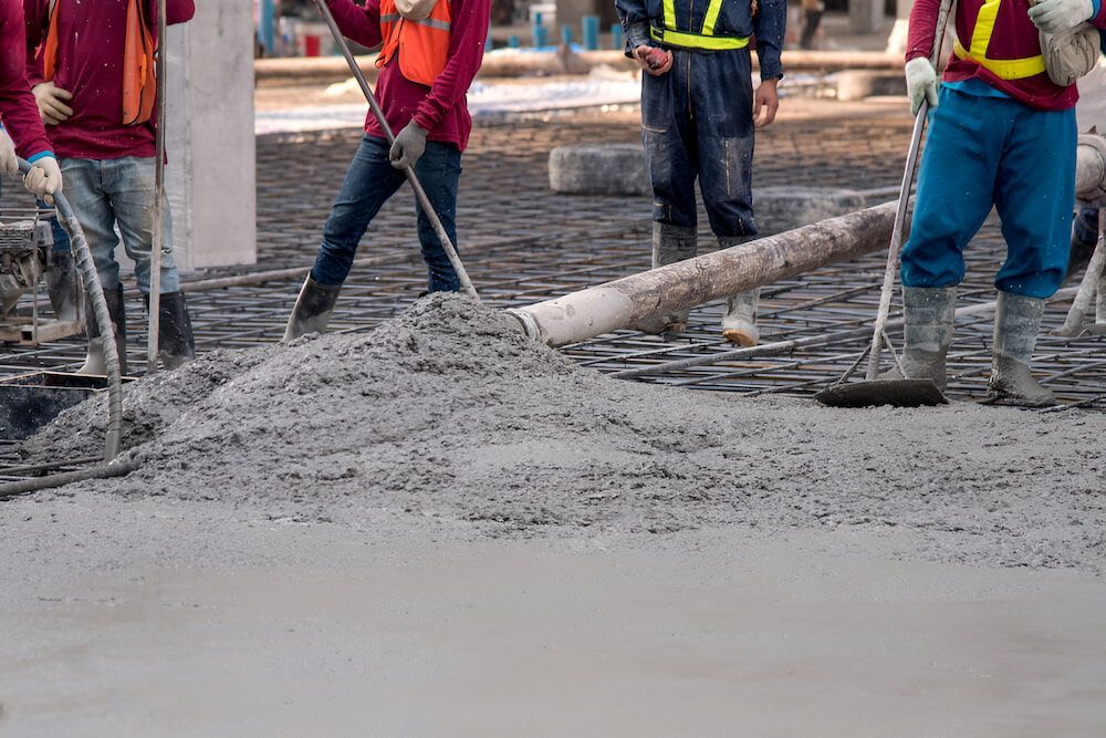 A Group Of Construction Workers Are Working On A Concrete Floor — Macquarie Valley Rock & Sand In Narromine, NSW