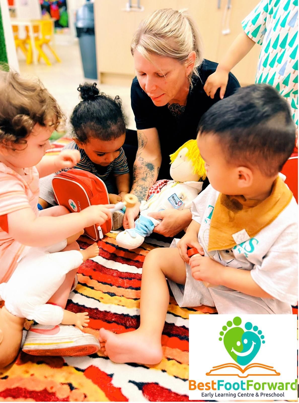 Adult and toddlers playing with toys on a colorful rug in a daycare setting