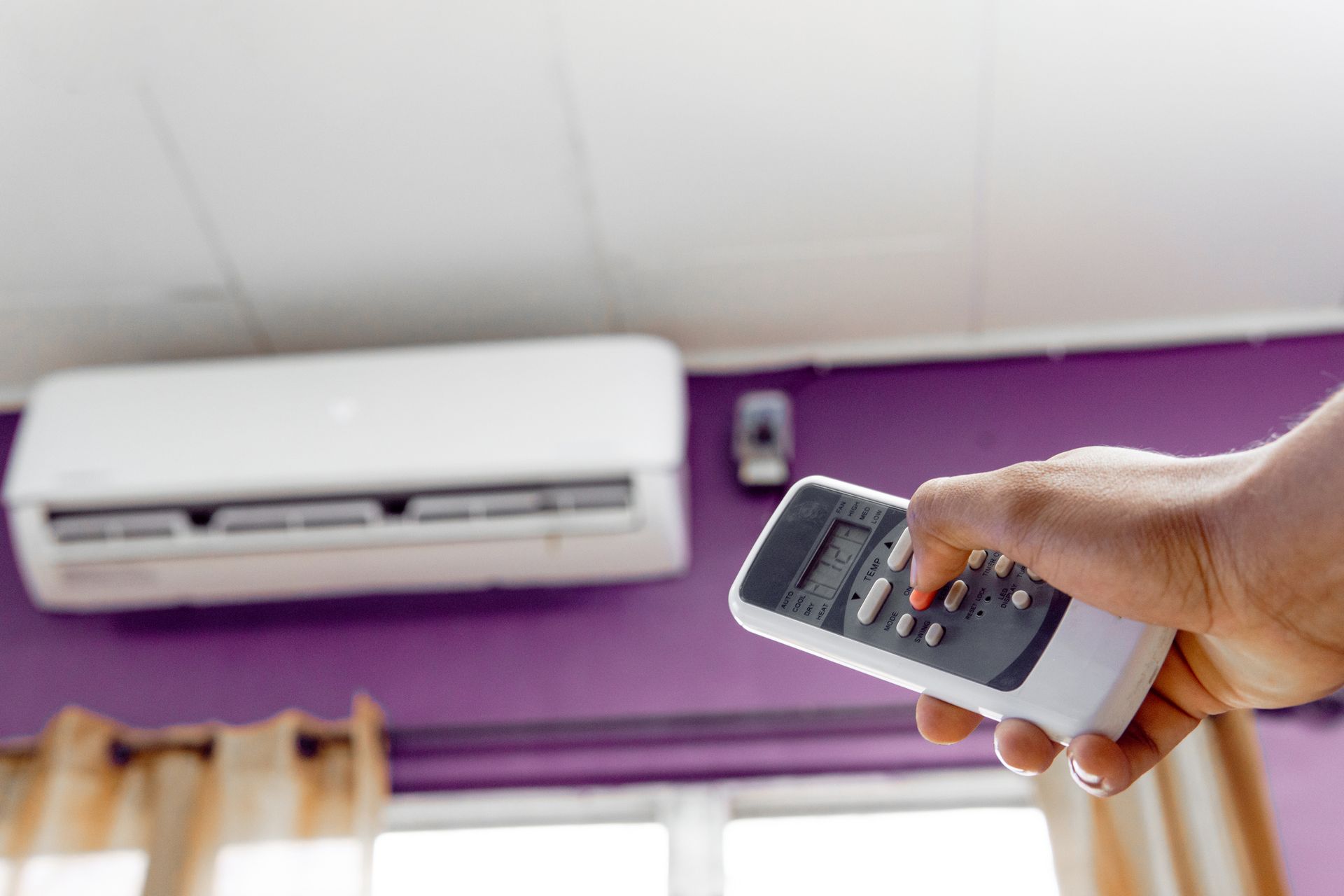 Air Conditioner Inside the Room with a Hand-Person Operating Remote Controller | Batemans Bay, NSW