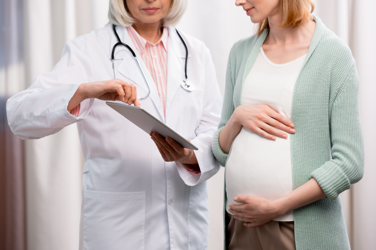 Healthcare provider discussing pregnancy care options with a pregnant woman during a medical visit