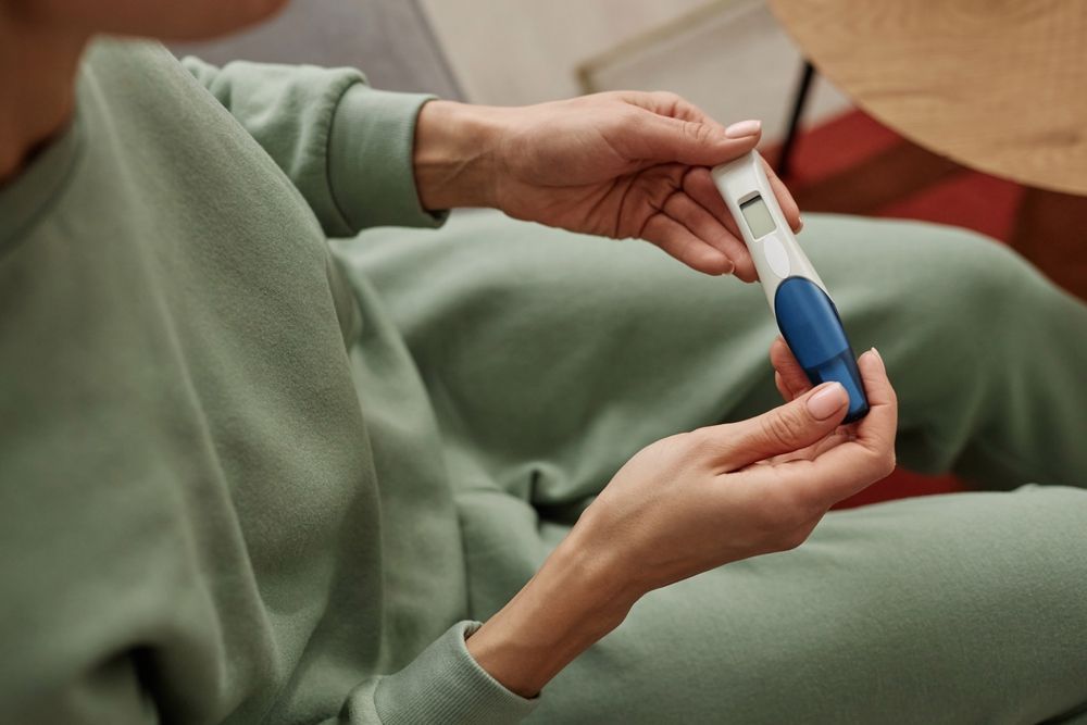 A woman holding an at-home pregnancy test.