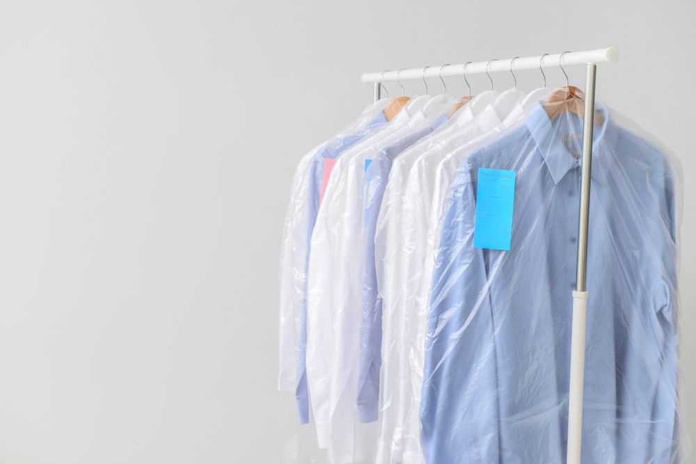 A Row Of Blue And White Shirts Hanging On A Rack — Buderim Laundrette In Buderim, QLD