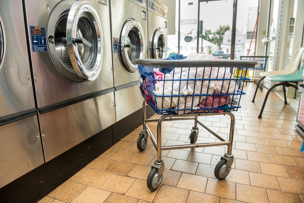A Laundromat With Washing Machines And A Shopping Cart Filled With Clothes — Buderim Laundrette In Buderim, QLD