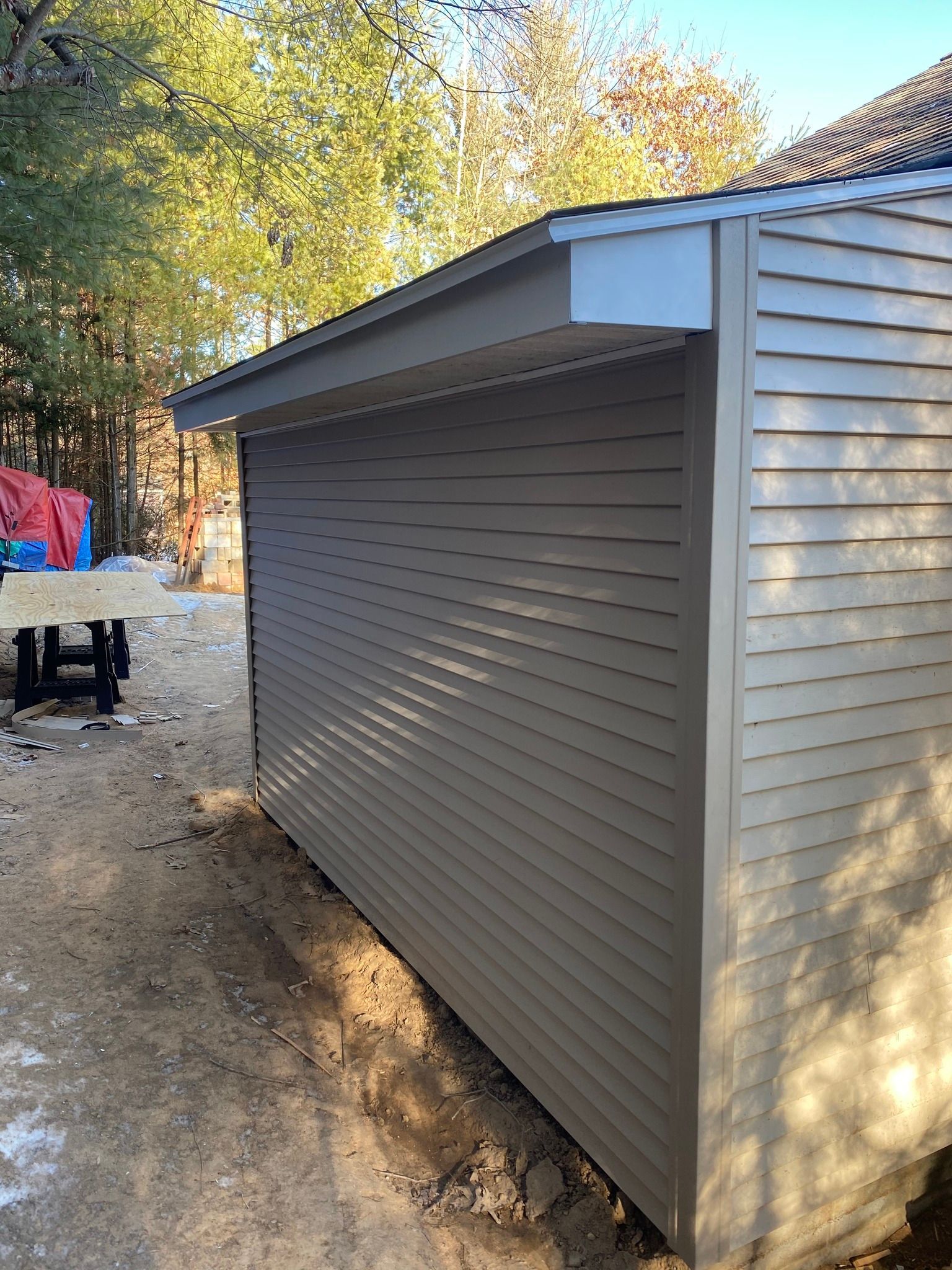 A shed is being built in the backyard of a house.