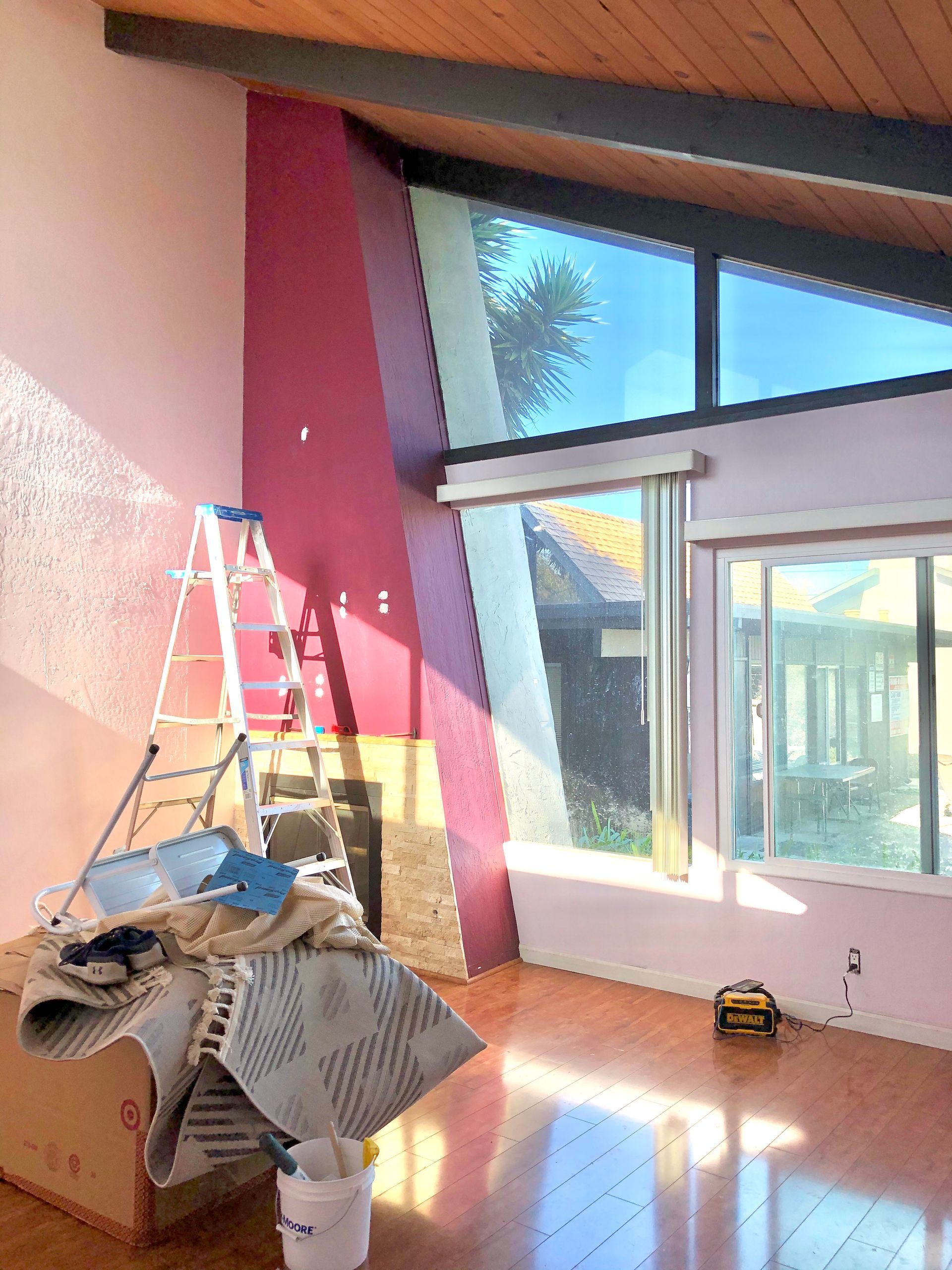 A room with a ladder and a bucket in it