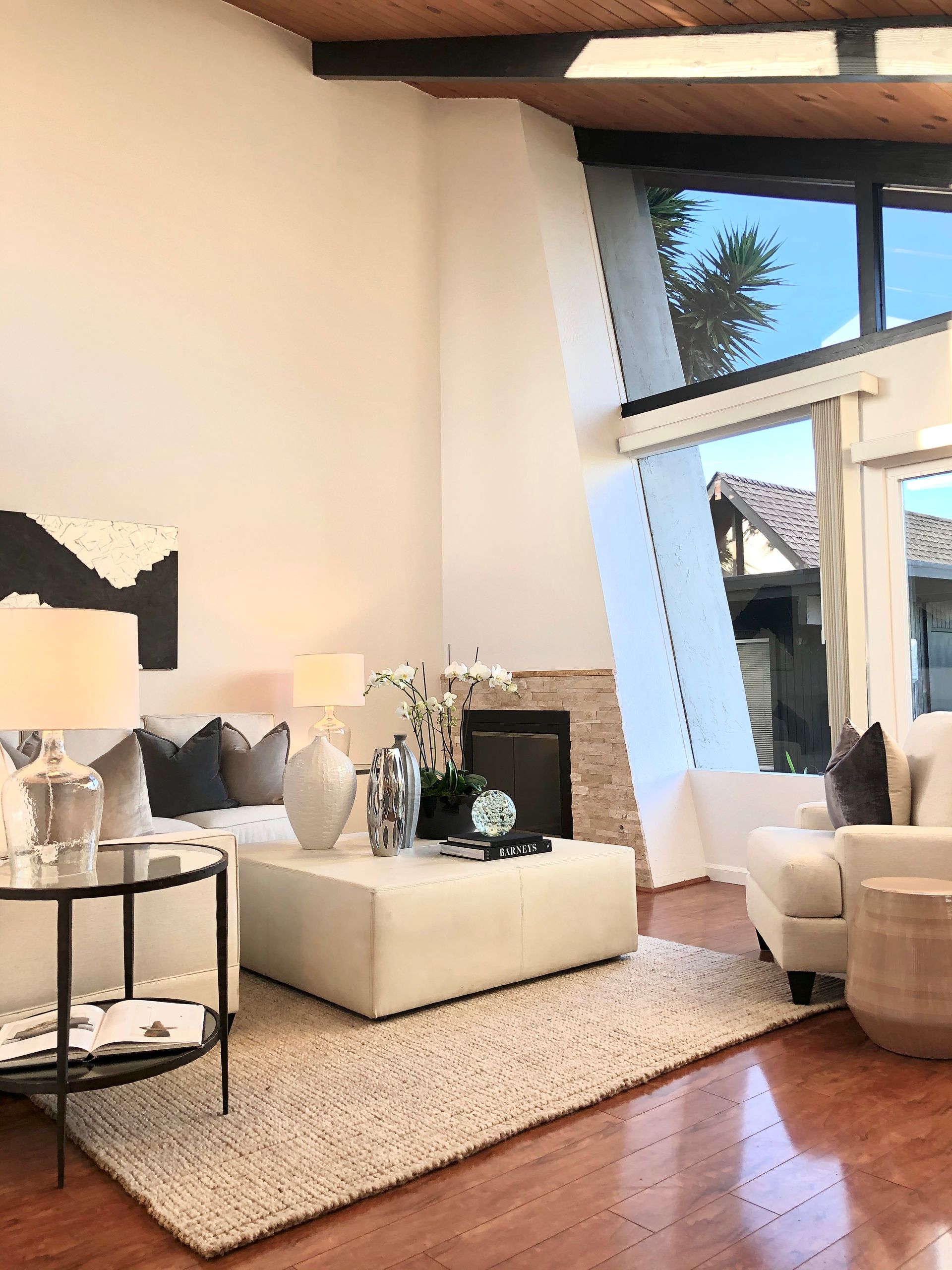 A living room with a couch , chair , coffee table and fireplace.
