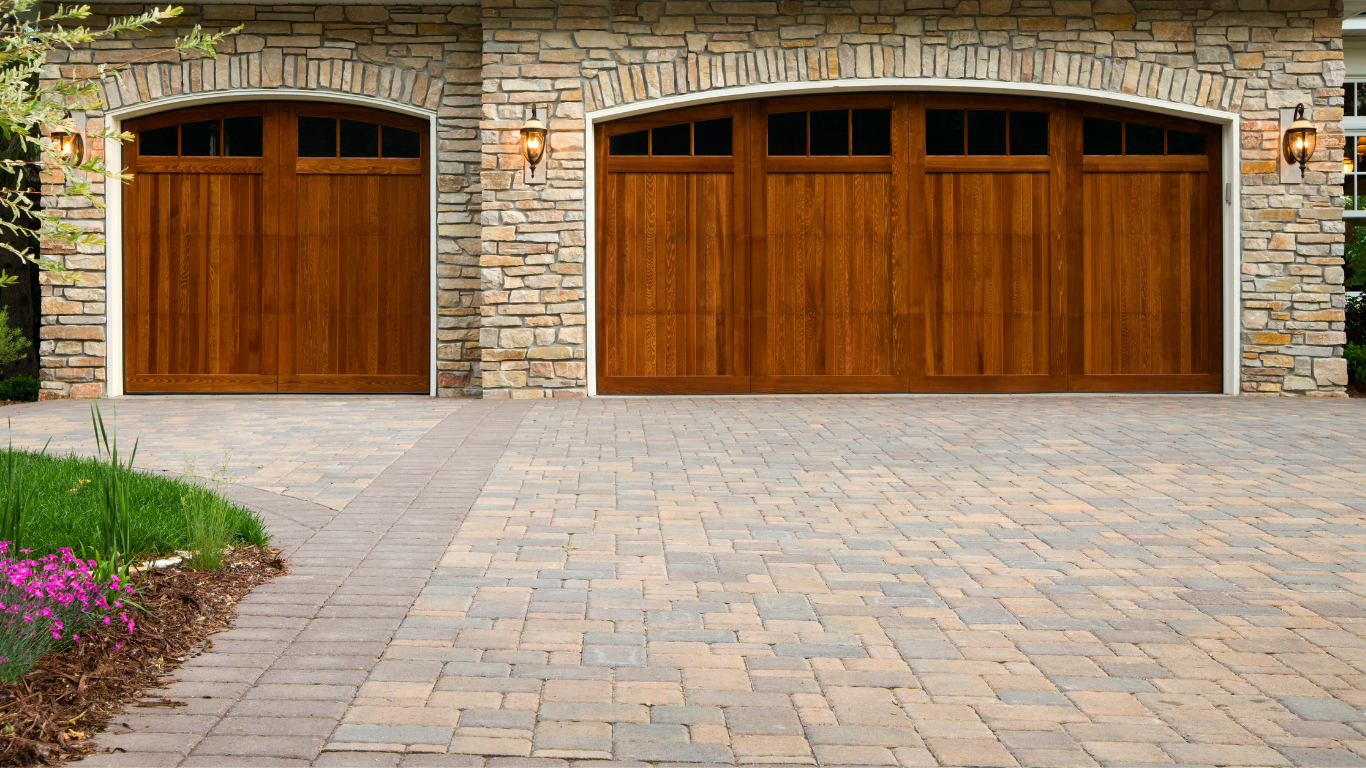 a stone building with two wooden garage doors