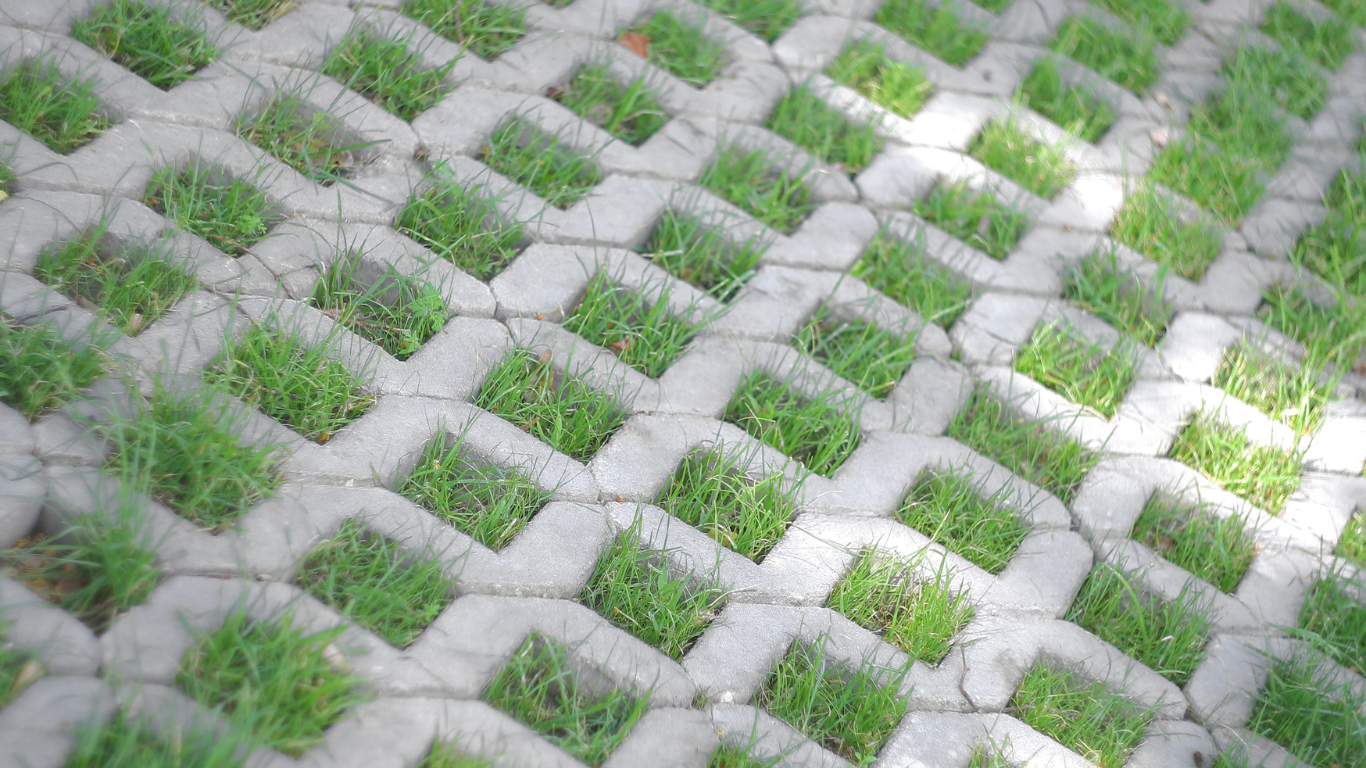 the grass is growing through the holes in the concrete